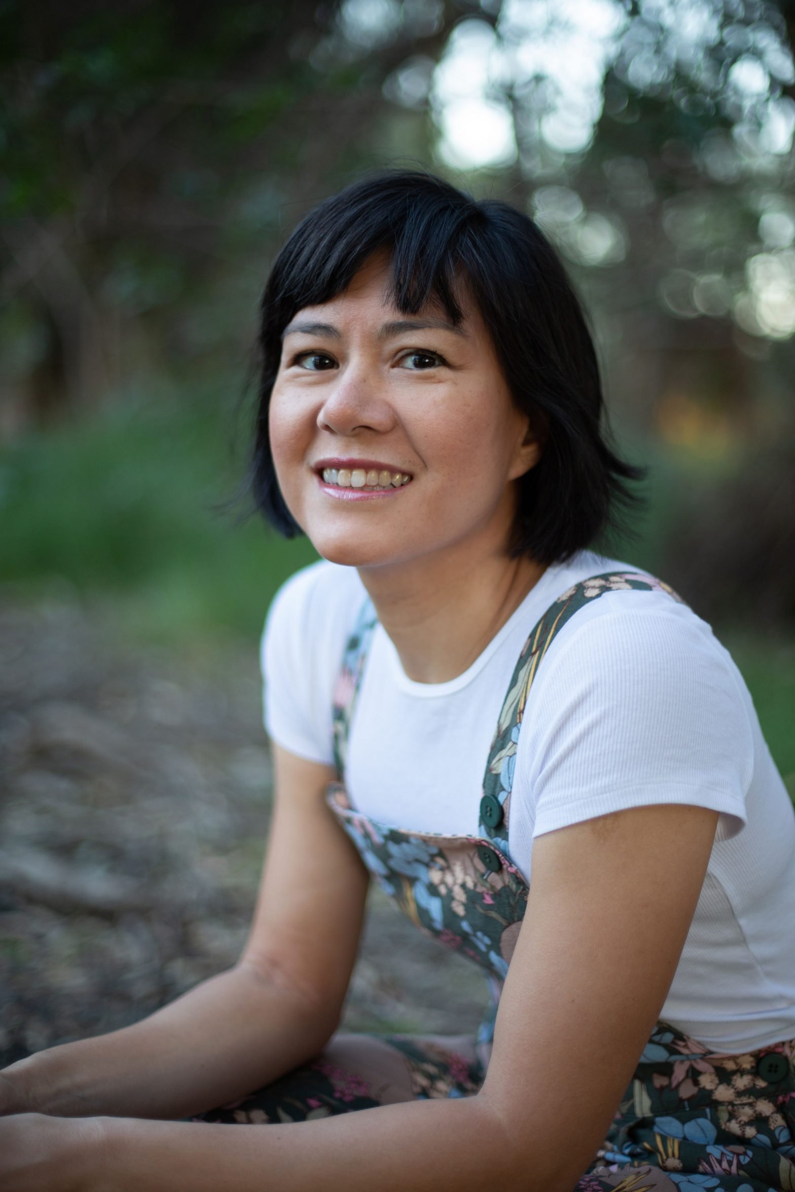 Photo of a woman with short black hair outdoors