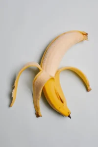 a photo of a half peeled banana